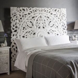 A handcrafted white wooden headboard
